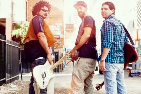 Band of musicians walking away in the streetの写真素材