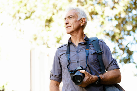 Senior man with camera in city