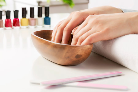 Woman in nail salon with hails in bath