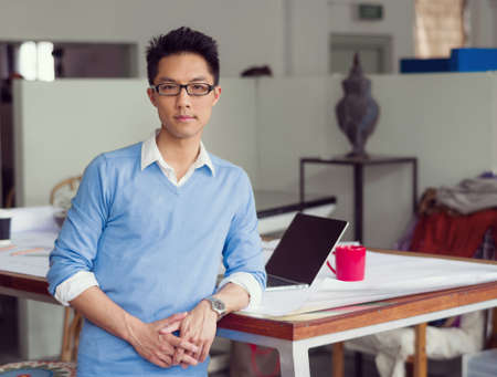 Portrait of young successful businessman in officeの写真素材