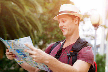 Happy young man with a mapの写真素材