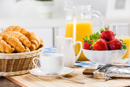 Breakfast with assortment of pastries, coffees and fresh strawberries