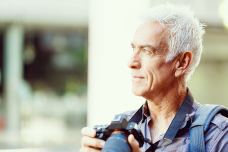 Senior man with camera in city