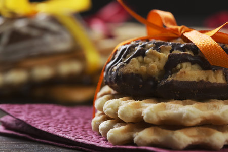 Stack of delicious cookies on table tied with ribbon