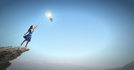 Happy young woman dreaming to fly in skyの写真素材