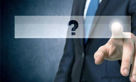 Close up of hand touching question mark icon with fingerの写真素材