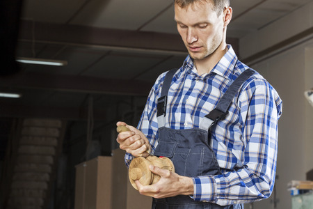 Young carpenter working with cutter in his studioの写真素材