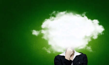 Businesswoman standing with his head in cloudの写真素材