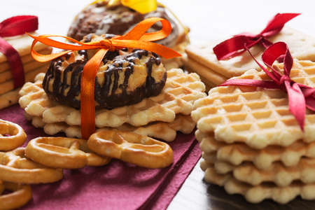 Stack of delicious cookies on napkin tied with ribbonの写真素材