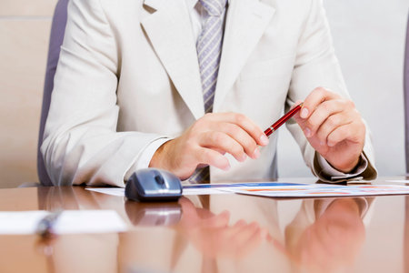 Businessman sitting at table and working in the office