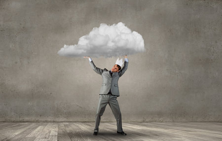 Young handsome businessman wearing white paper crownの写真素材