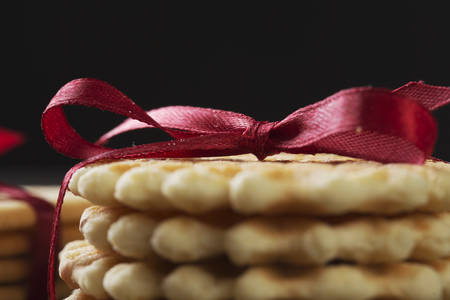 Stack of delicious cookies on napkin tied with ribbonの写真素材
