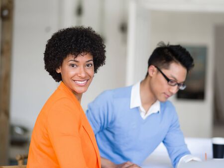 Two desingers working on a project together in officeの写真素材