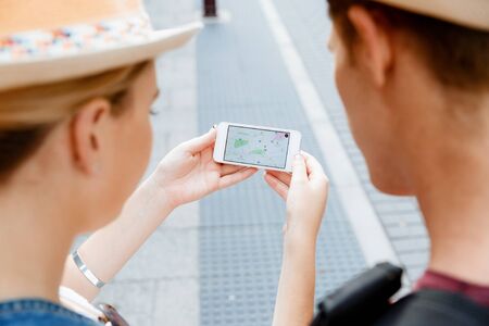Tourists using navigation app on the mobile phone.の写真素材