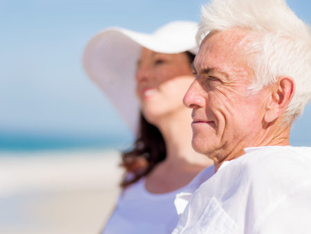 Couple sitting on the beachの写真素材