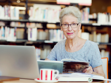 Elderly lady working with laptopの写真素材