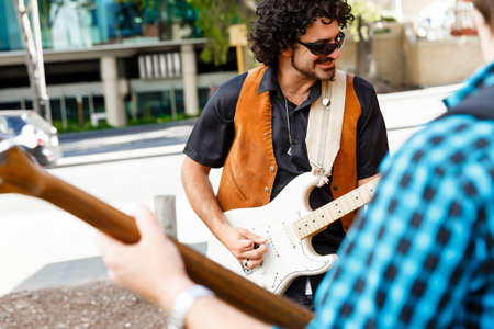A street musician playing his guitarの写真素材