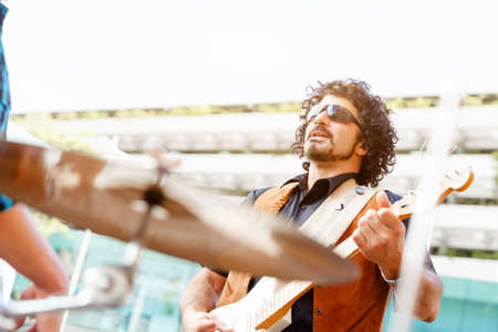 A street musician playing his guitarの写真素材