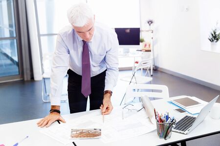Businessman in office working with papersの写真素材