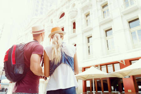 Happy young couple as tourists with a cameraの写真素材