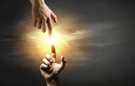 Close up of two hands reaching each other with fingersの写真素材