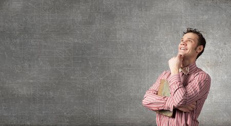 Portrait of handsome young thoughtful man with hand on chinの写真素材
