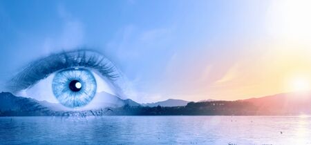 Close up of female eye with panoramic view at backgroundの写真素材