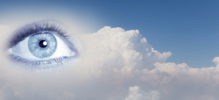 Close up of female eye on blue sky backgroundの写真素材
