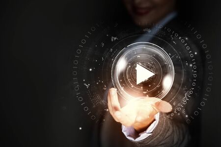 Close up of businesswoman pressing media play iconの写真素材