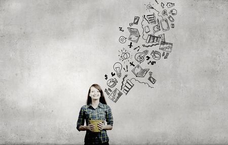 Young girl holding bucket with flying out sketchesの写真素材