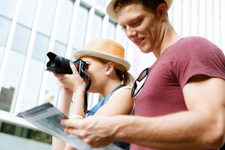 Happy young couple as tourists with a cameraの写真素材