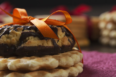 Stack of delicious cookies on table tied with ribbonの写真素材