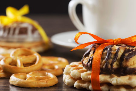 Stack of delicious cookies on napkin tied with ribbon