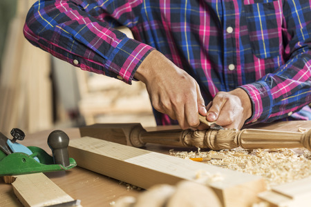 Close up of carpenters hands working with cutter in his studioの写真素材