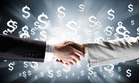 Close up of business handshake on digital の写真素材