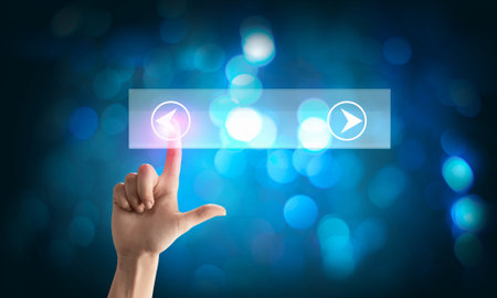 Close up of hand pushing icon of media player