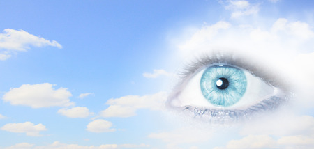 Close up of female eye on blue sky の写真素材