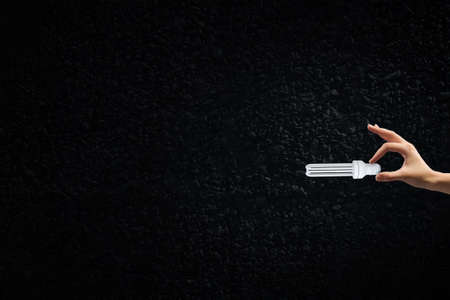 Close up of male hand holding light bulbの写真素材