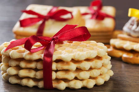 Stack of delicious cookies on napkin tied with ribbonの写真素材