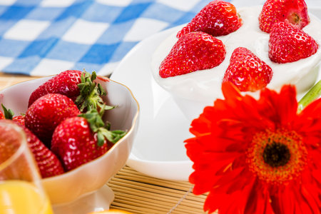 Breakfast with assortment of pastries, coffees and fresh strawberriesの写真素材