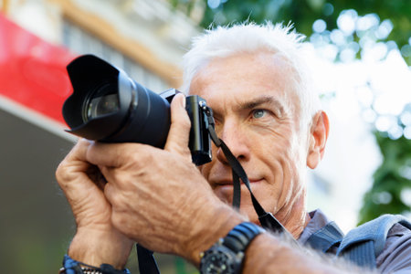 Senior man with camera in city