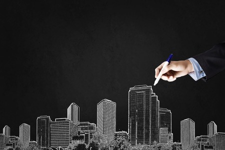 Close up of hand drawing urban city buildingsの写真素材