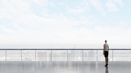 Back view of businesswoman standing on roof looking at cityの写真素材