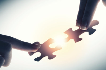 Close up of hands connecting puzzle element and making jigsaw complete