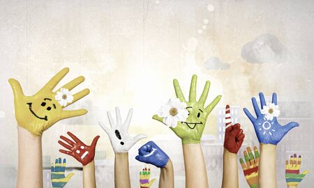 Image of human hands in colorful paint with smilesの写真素材