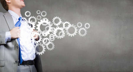 Young businessman acting like super hero of creativityの写真素材