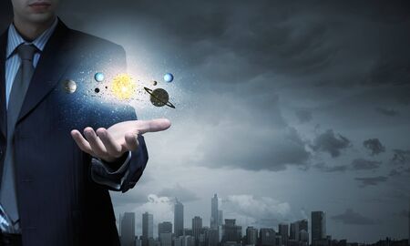 Close up of human hand with planet of sun systemの写真素材