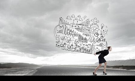 Young businesswoman carrying her great business plan on backの写真素材