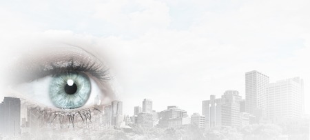 Bird eye view of modern city with human female eyeの写真素材