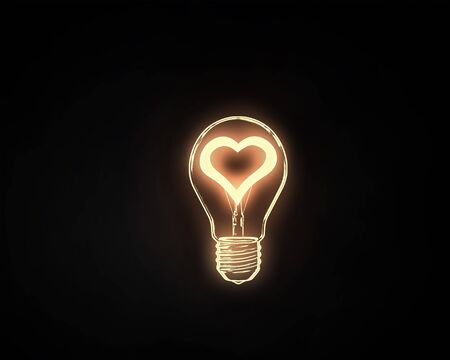 Heart shape in light bulb on black backgroundの写真素材
